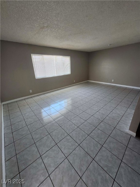 Unfurnished room featuring light tile patterned fl