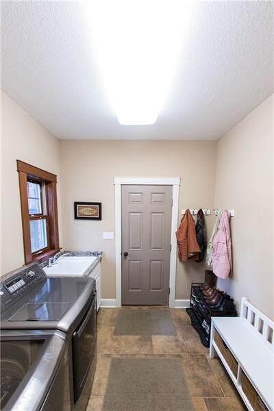 The 8x8 laundry room off the garage also serves as