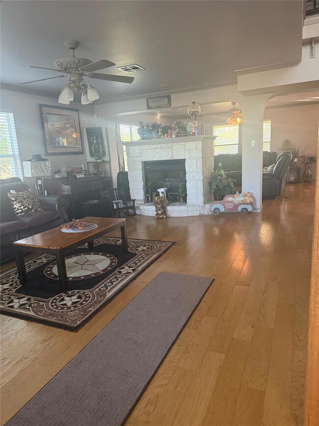 Living area featuring visible vents, arched walkw