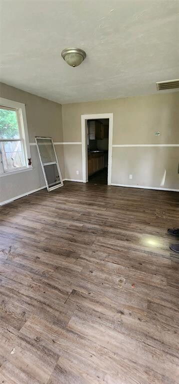 Unfurnished living room featuring hardwood / wood-