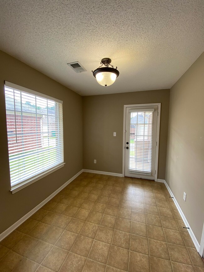 Unfurnished room with tile flooring and a textured