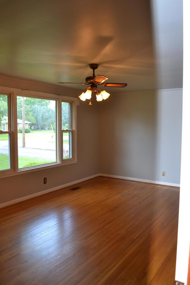 Living room with hard wood floors and ceiling fan