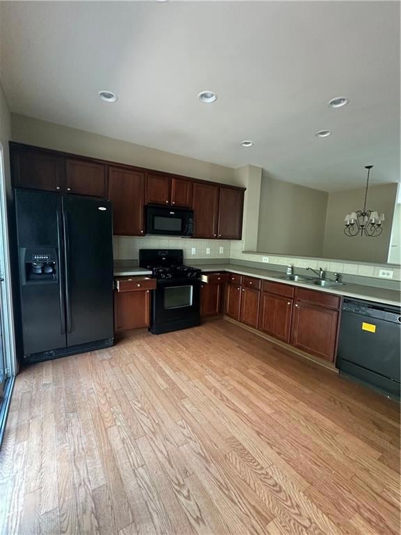 Kitchen featuring light wood finished floors, refr