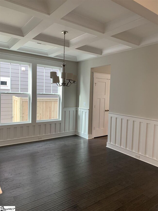 Offers real wood wainscoting and coffered ceiling 