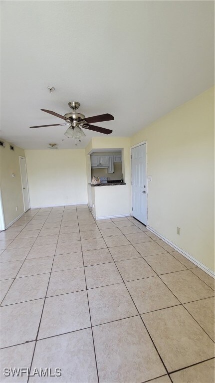 Unfurnished living room featuring baseboards, ceil