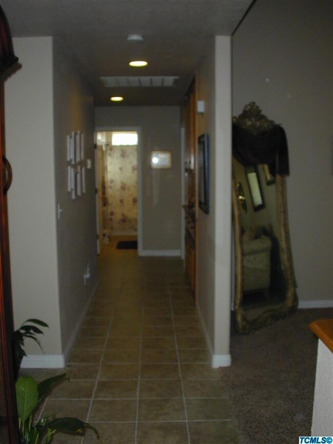 This wide newly tiled hall leads to the