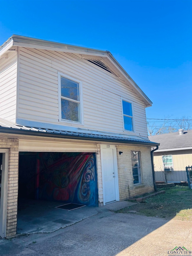 Rear view of property with a garage