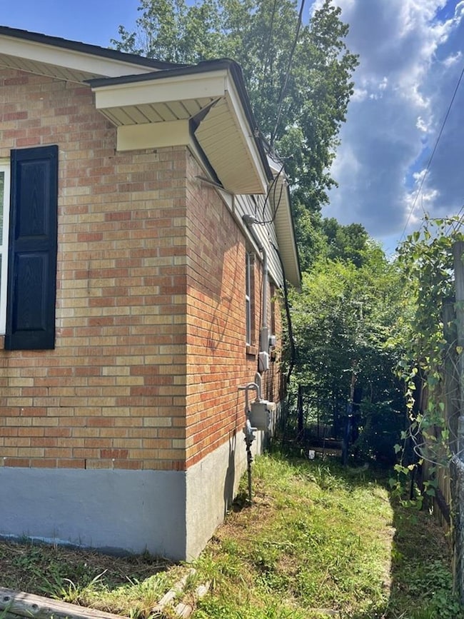 View of side of property featuring brick siding