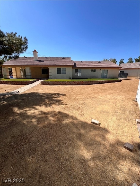 Rear view of house with a chimney