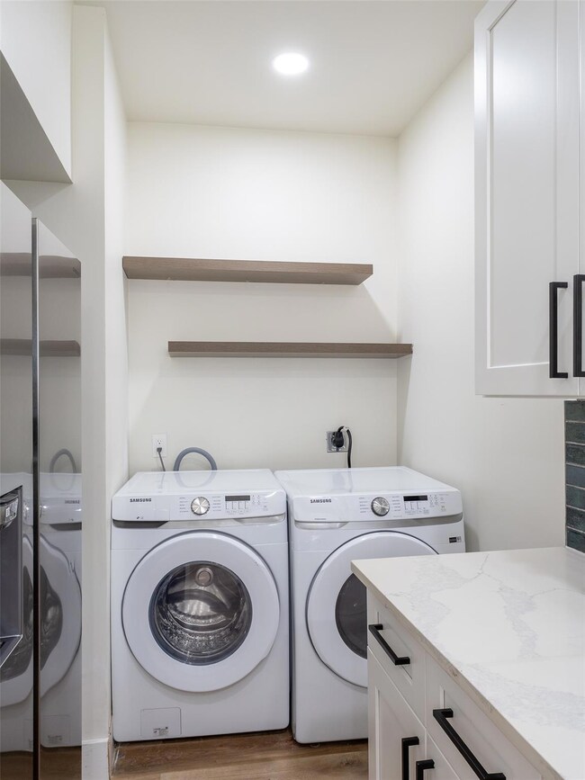 Laundry room with washer and clothes dryer, wood 
