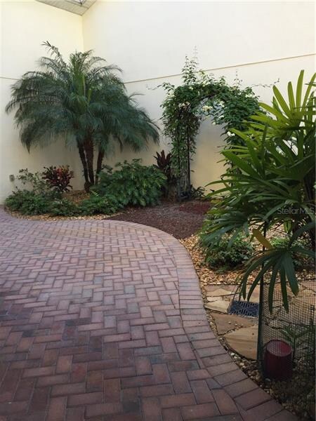Courtyard with pavers and Florida landscaping.