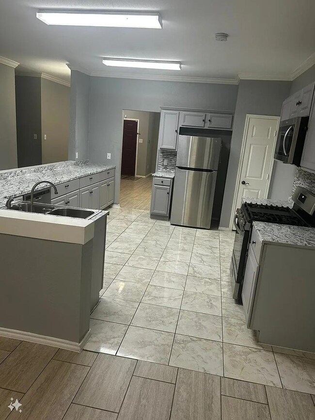 Kitchen featuring gray cabinets, crown molding, st