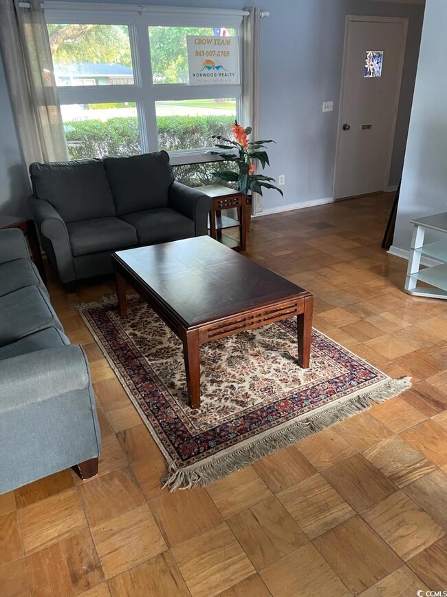 Living room featuring baseboards and plenty of natural light