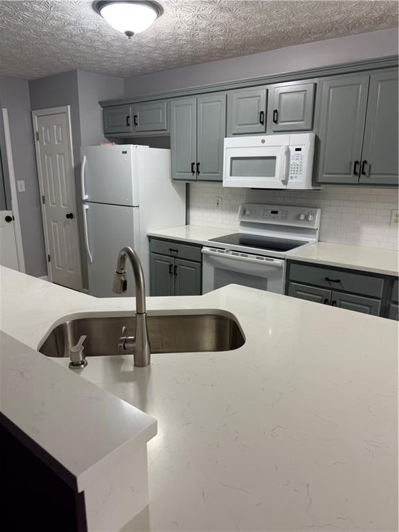 Kitchen with tasteful backsplash, a sink, fridge, 