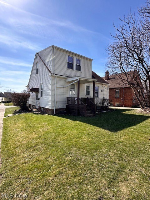 Rear view of house with a lawn