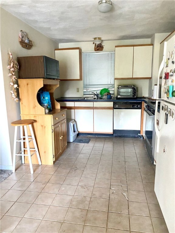 kitchen. Tile floor needs repair