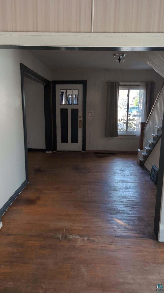 Interior space with dark hardwood / wood-style flo