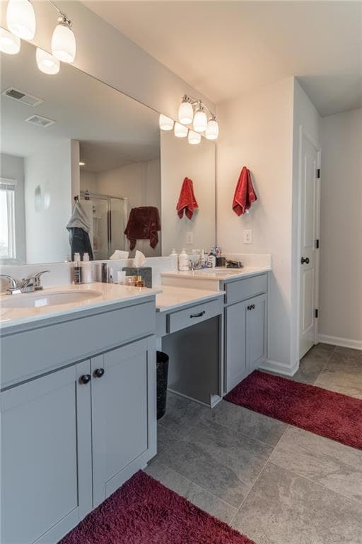 Bathroom with visible vents, vanity, and a stall s