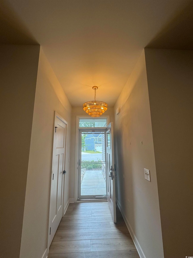 Entryway with a chandelier and wood finished floors