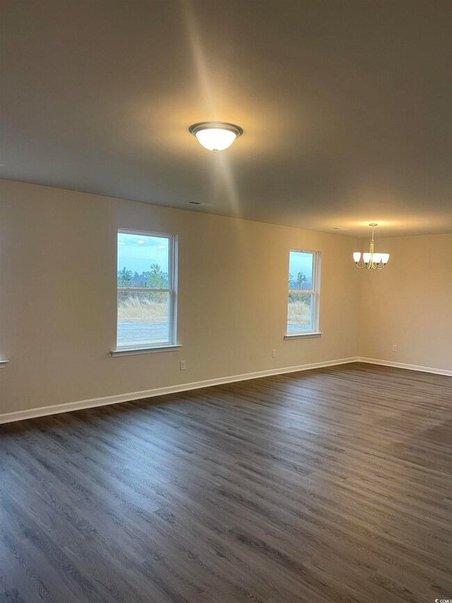 Spare room featuring dark hardwood / wood-style fl