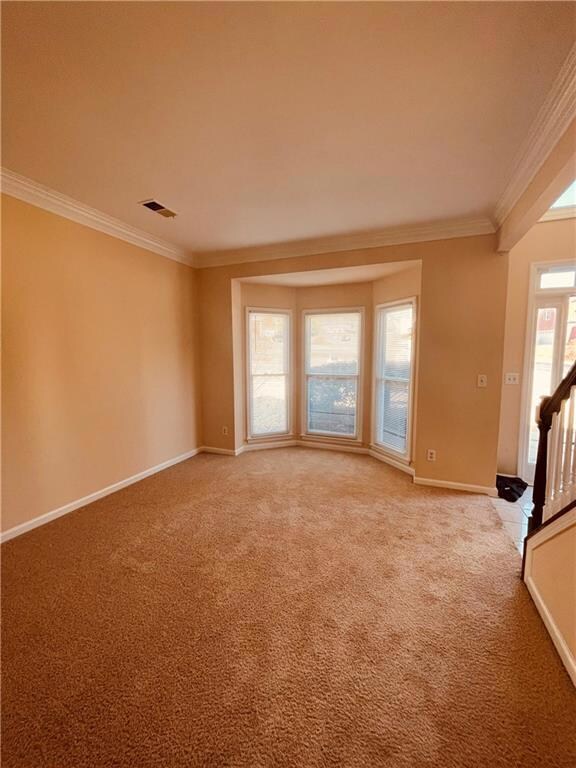 Unfurnished room with light colored carpet, visibl