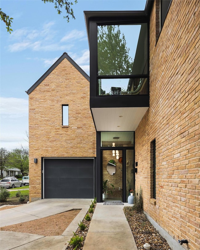 View of property exterior featuring concrete driv