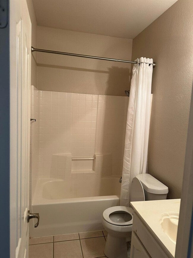 Full bathroom with vanity, toilet, tile patterned 