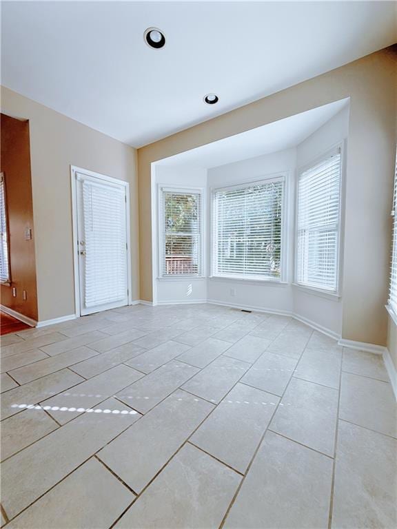 Spare room featuring light tile patterned floors and recessed lighting