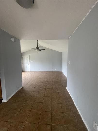 Spare room featuring ceiling fan, vaulted ceiling