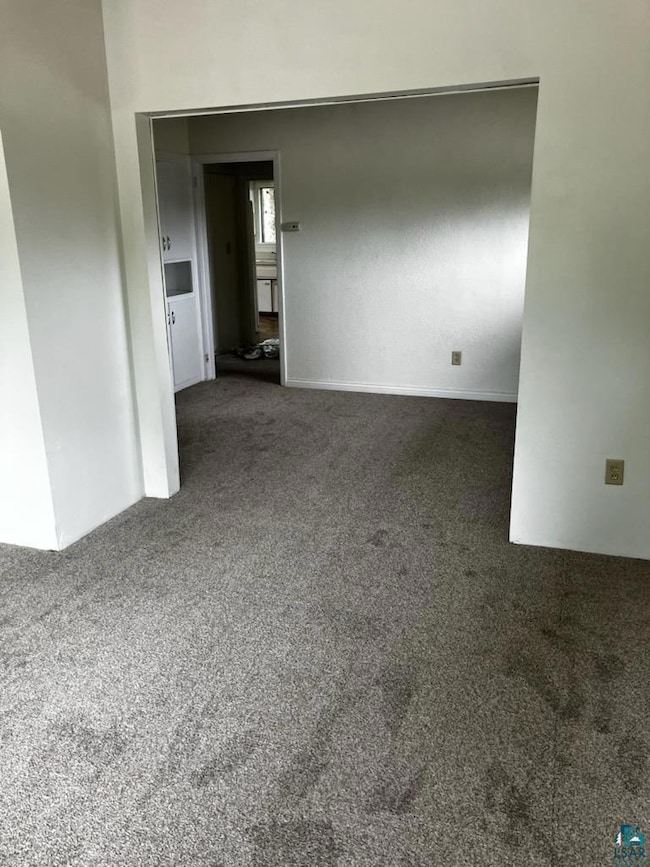 Empty room with carpet flooring
