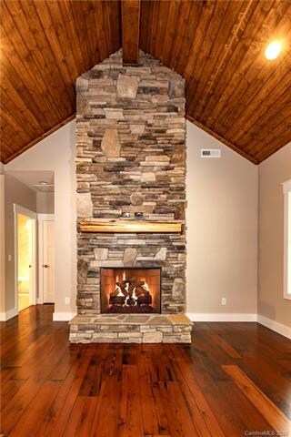 Floor to ceiling rock gas fireplace