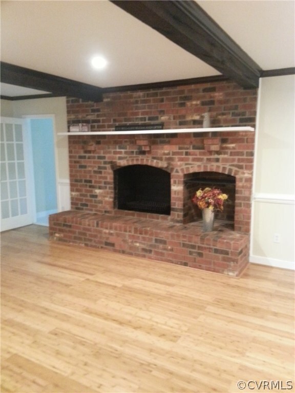 Living Room with Large Brick Wood Burning Fireplac