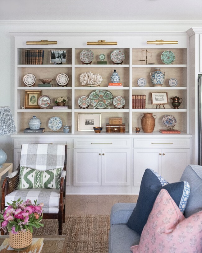 Custom built-ins with grasscloth wallcovering and adjustable shelving