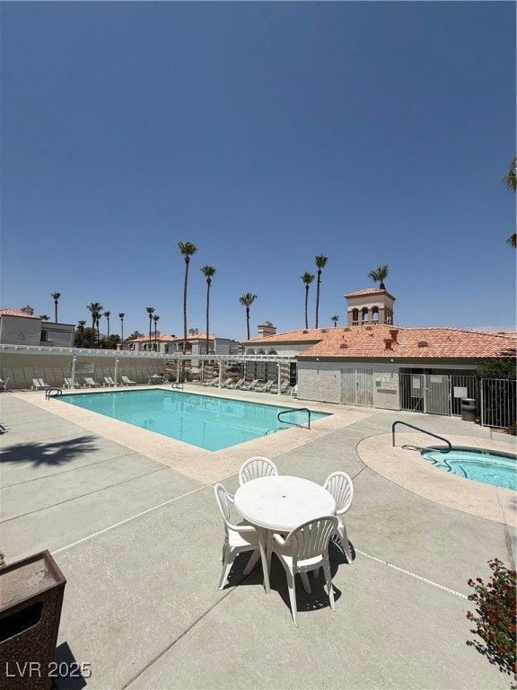 Community pool with a patio