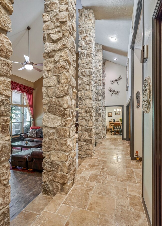 View of the stone columns into the family room and the vaulted ceiling.
