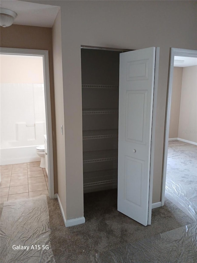 Hallway with entrance to bedrooms and linen closet