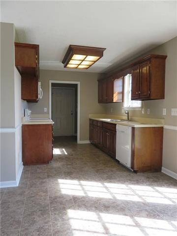 Kitchen with new flooring, new dishwasher, fresh paint and lots of storage