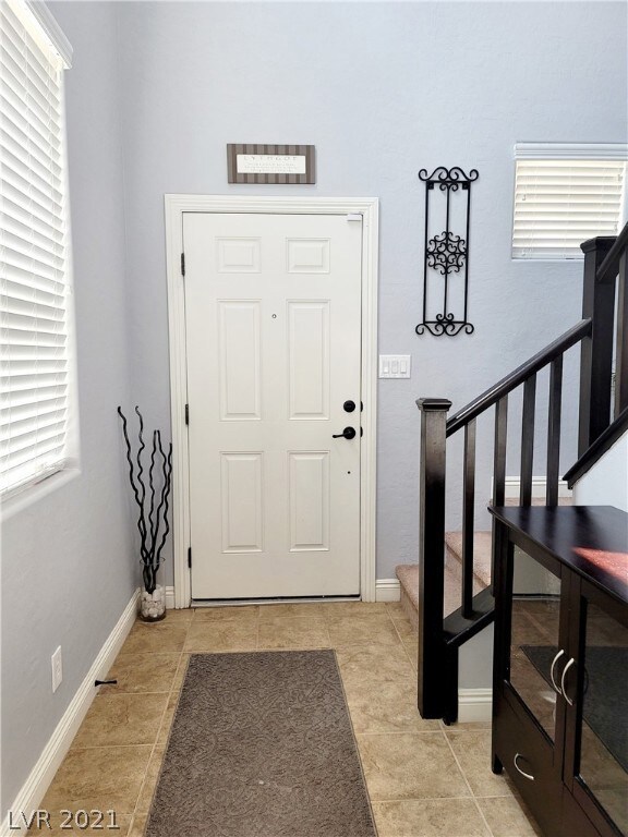 Entry Foyer With Tile Floors & Neutral Paint.
