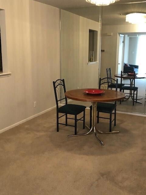 Dining area featuring baseboards and carpet