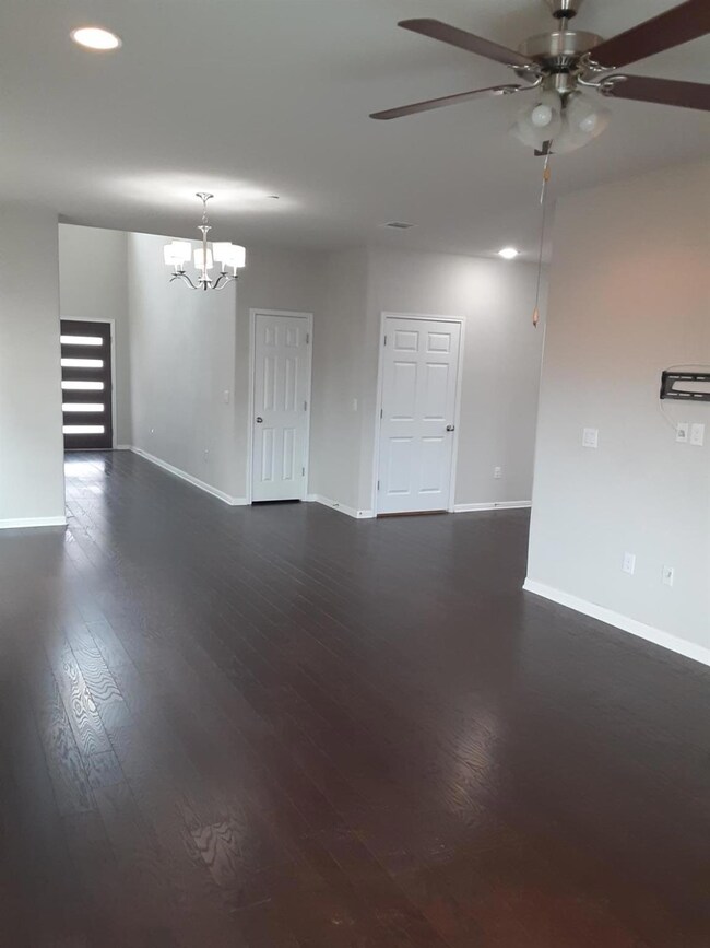 Spare room featuring recessed lighting, dark wood