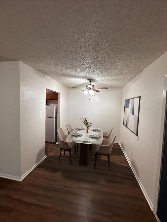 Carpeted bedroom with a ceiling fan, baseboards, a