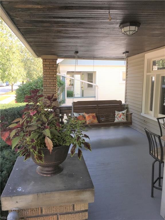 This Spacious Front Porch is Exclusive to the 1st Flr Residents.  Offering a Newly added wooden swing & additional Hit Top Tble w/ Chairs for extra seating.  (shown on right).