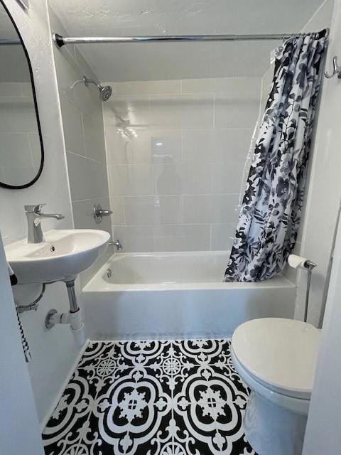 Bathroom with shower / bathtub combination with curtain, toilet, and tile patterned flooring