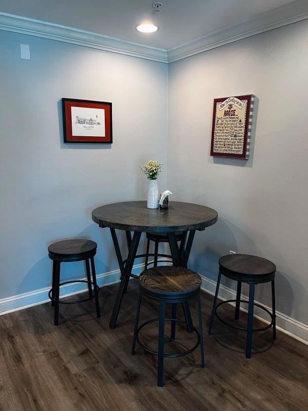 Dining space with crown molding and dark wood fin