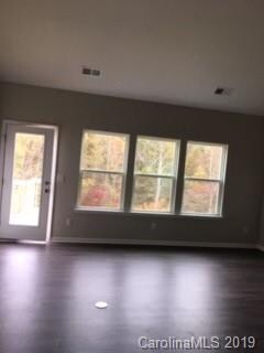Family room looking out the rear of home onto wood