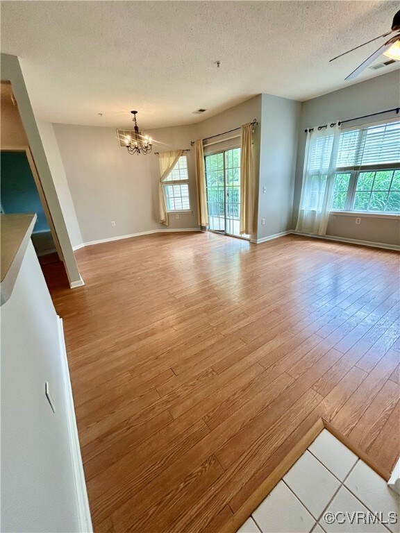 living  with a chandelier, wood finished floors, a