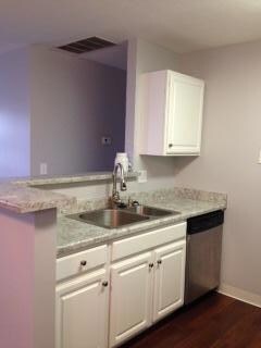 Kitchen sink looks into living area