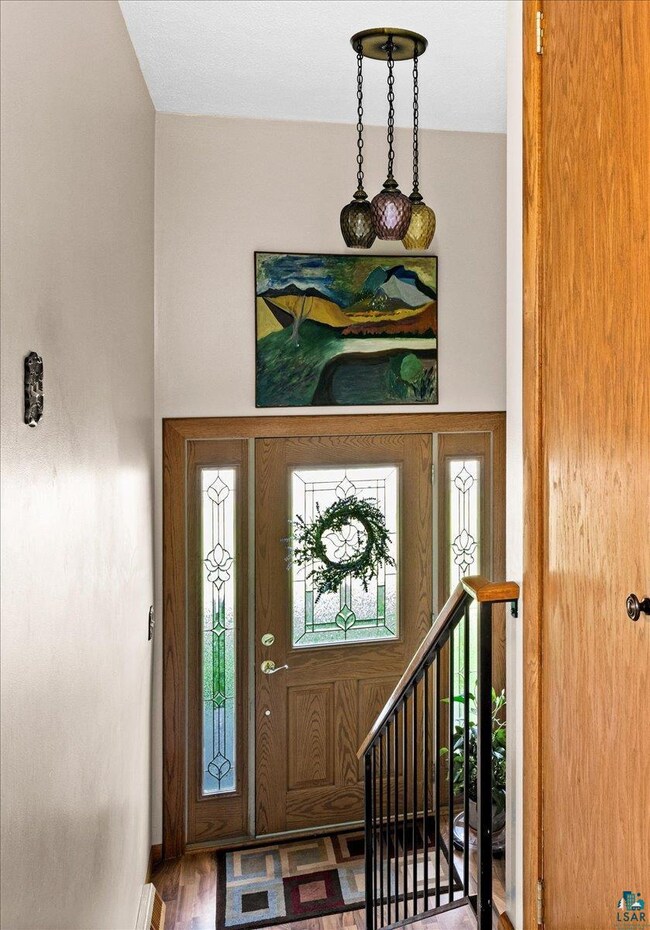 Entrance foyer with hardwood / wood-style floors