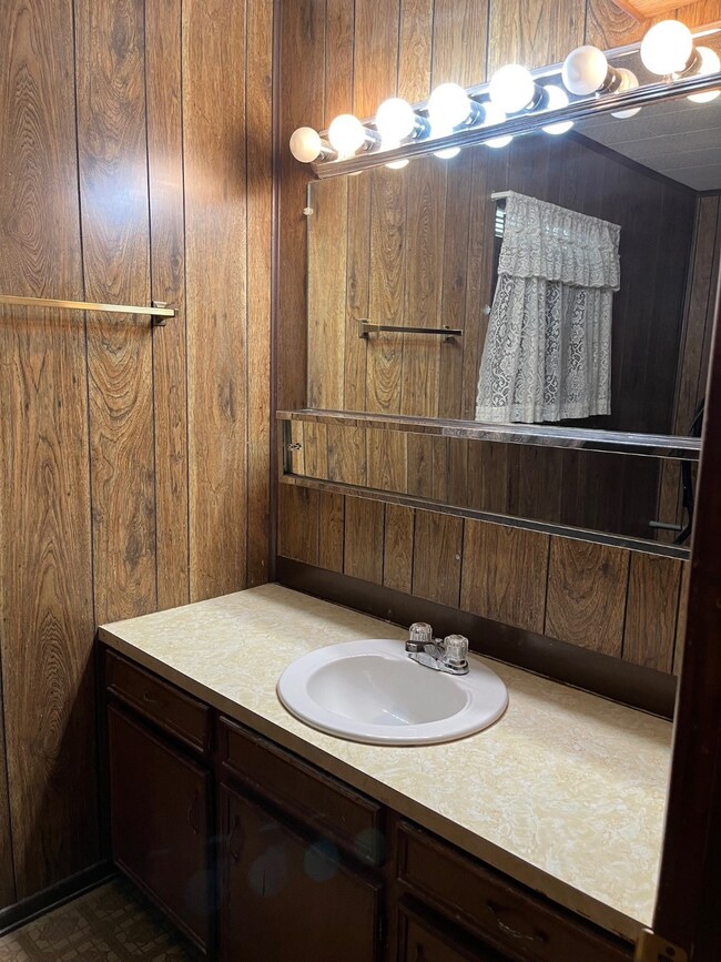 This photo shows a vintage-style vanity with wood