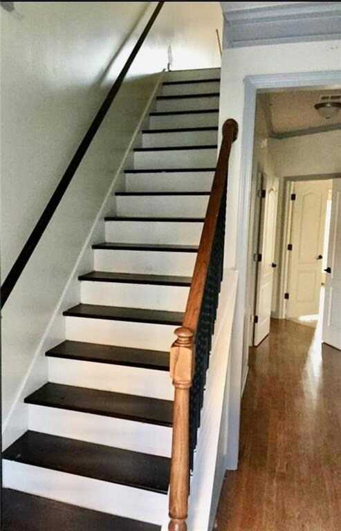 Stairs featuring wood finished floors